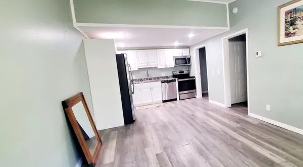 a view of a kitchen with a refrigerator a stove top oven
