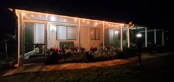 a view of a house with backyard porch and garden
