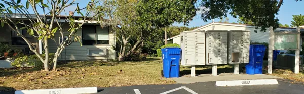 a view of a house with backyard and trees