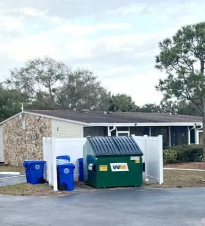 a view of a parking space with cars parked on the roadside