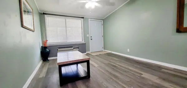 a view of an empty room and wooden floor