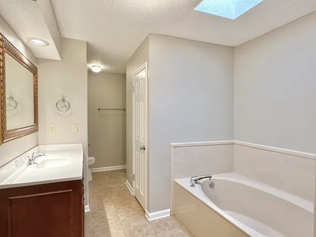 a bathroom with a bathtub and a sink