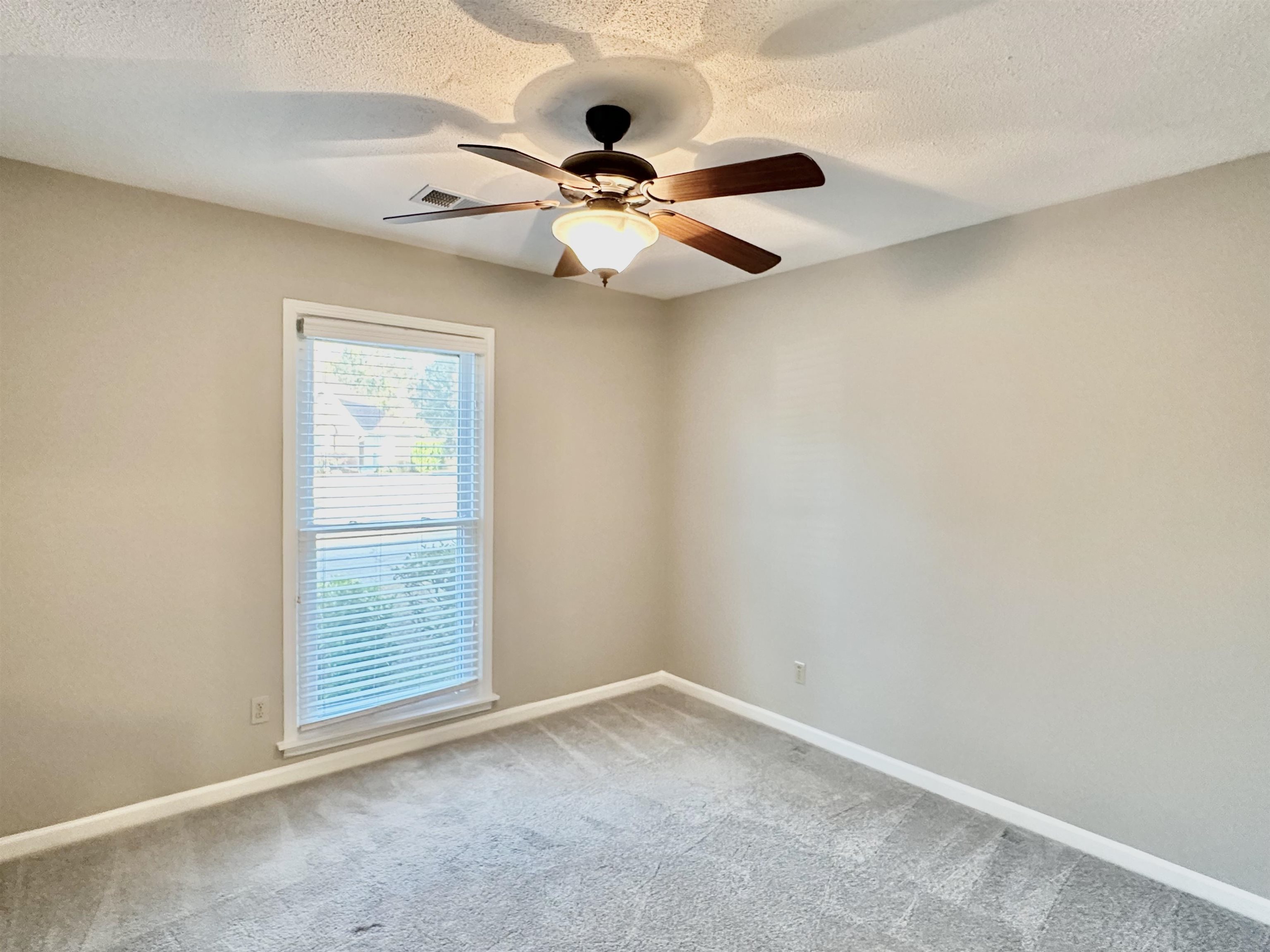 7475 Kingsland Drive Memphis, TN 38125 - Photo 18 of 32 an empty room with windows and fan