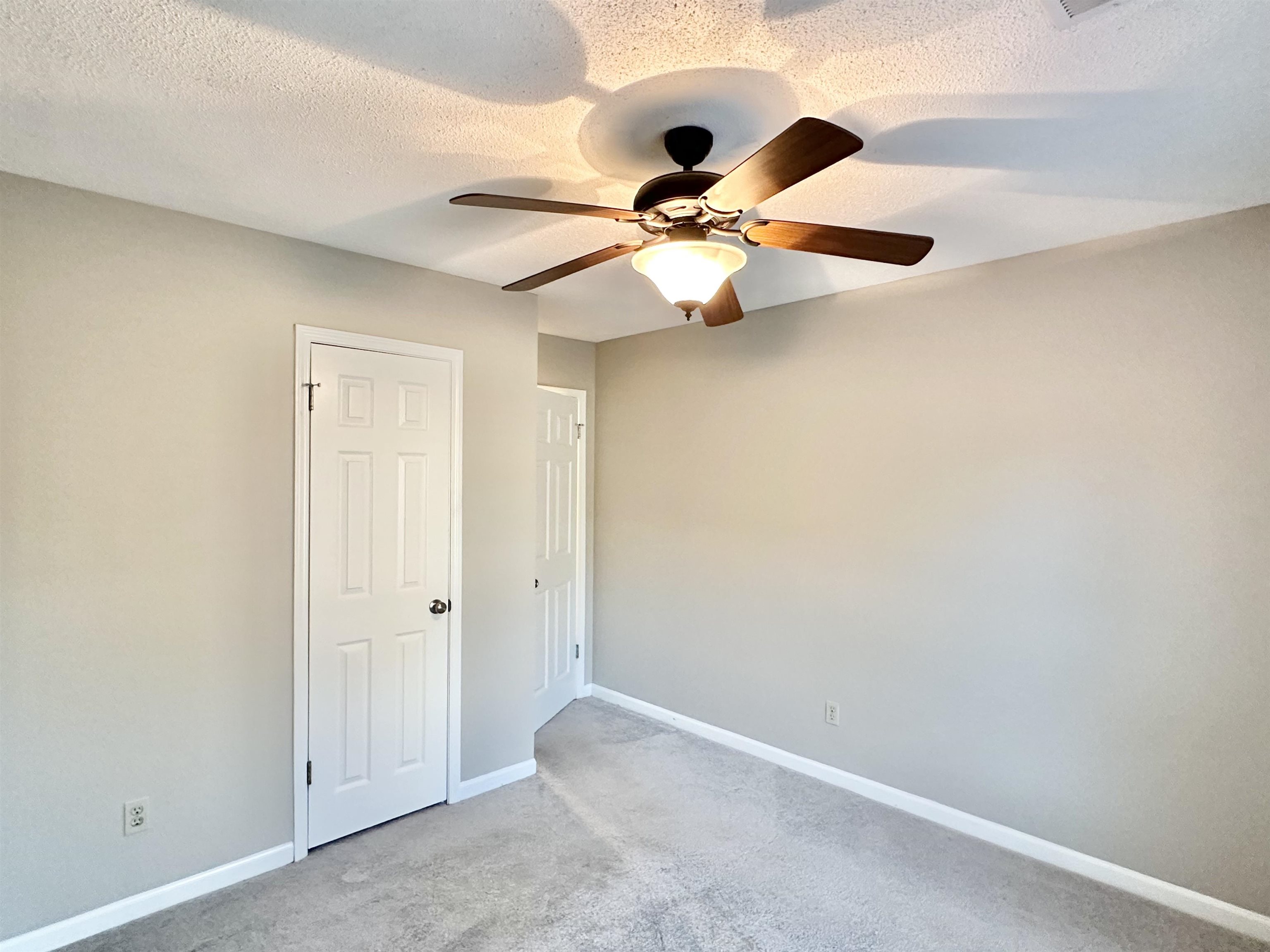 7475 Kingsland Drive Memphis, TN 38125 - Photo 19 of 32 an empty room with chandelier fan
