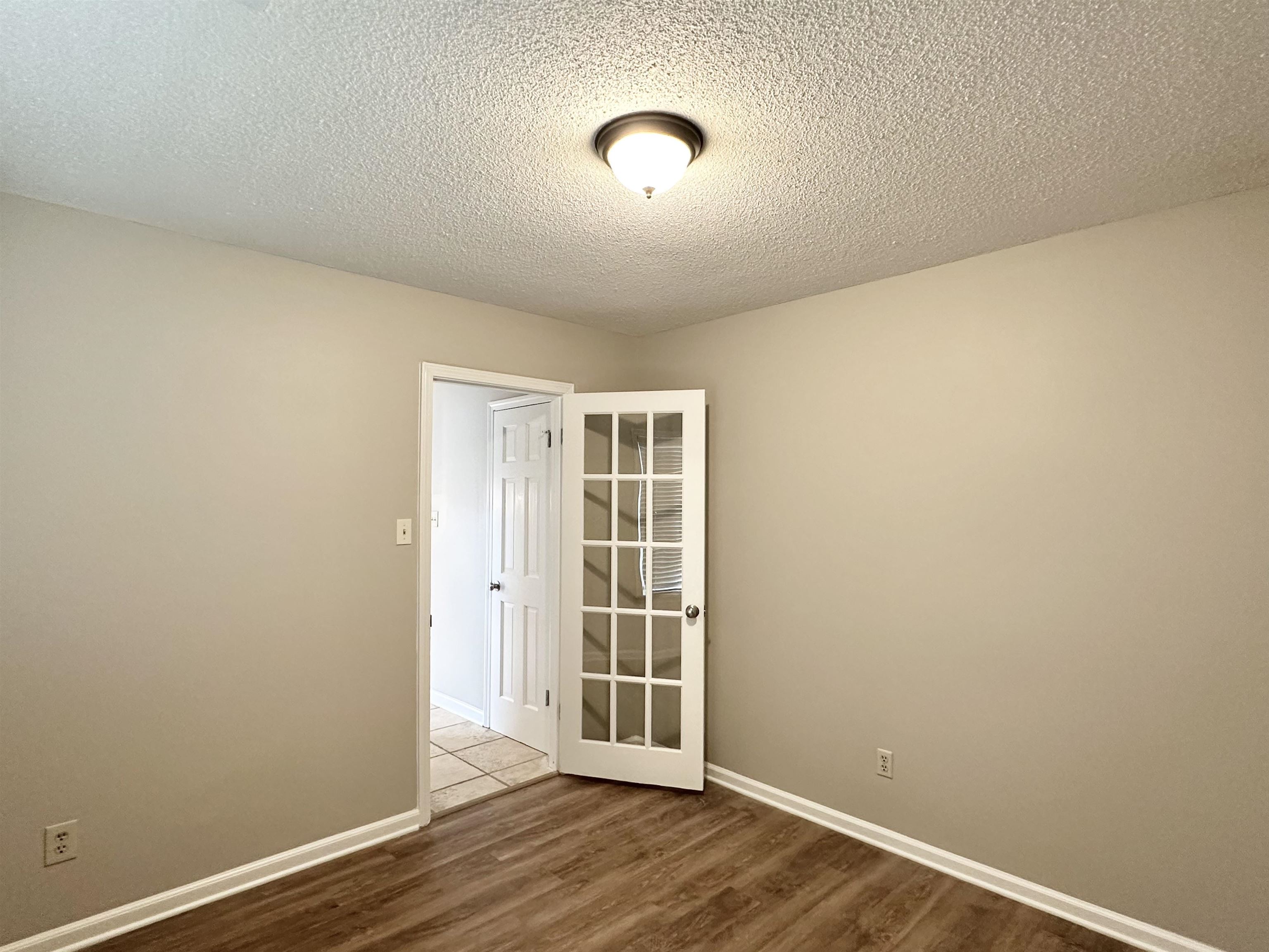 7475 Kingsland Drive Memphis, TN 38125 - Photo 21 of 32 a view of a room with wooden floor and windows