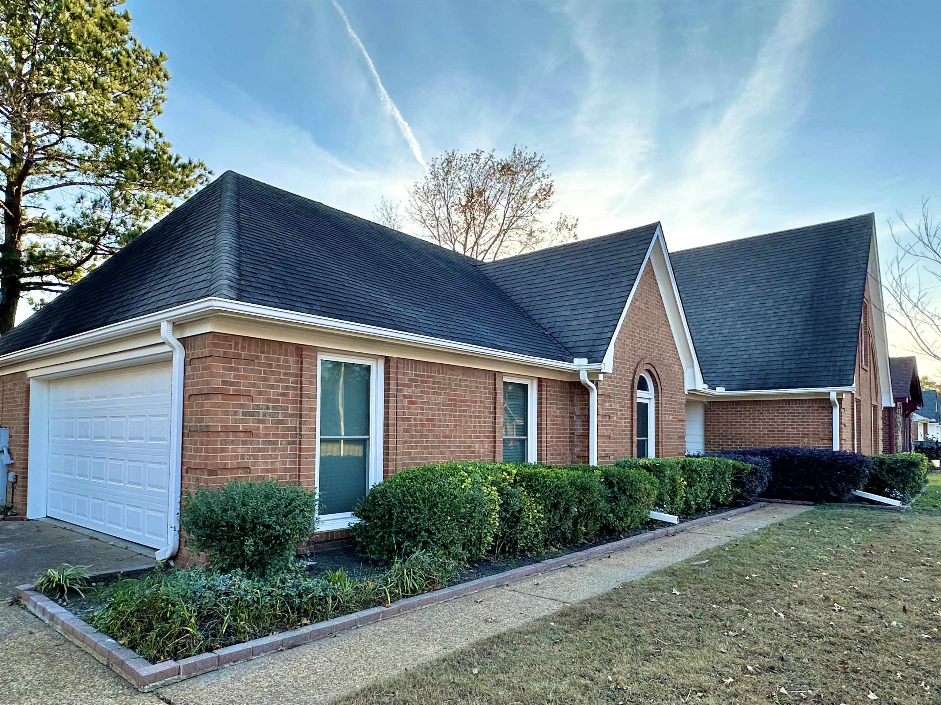 7475 Kingsland Drive Memphis, TN 38125 - Photo 3 of 32 a front view of a house with a yard
