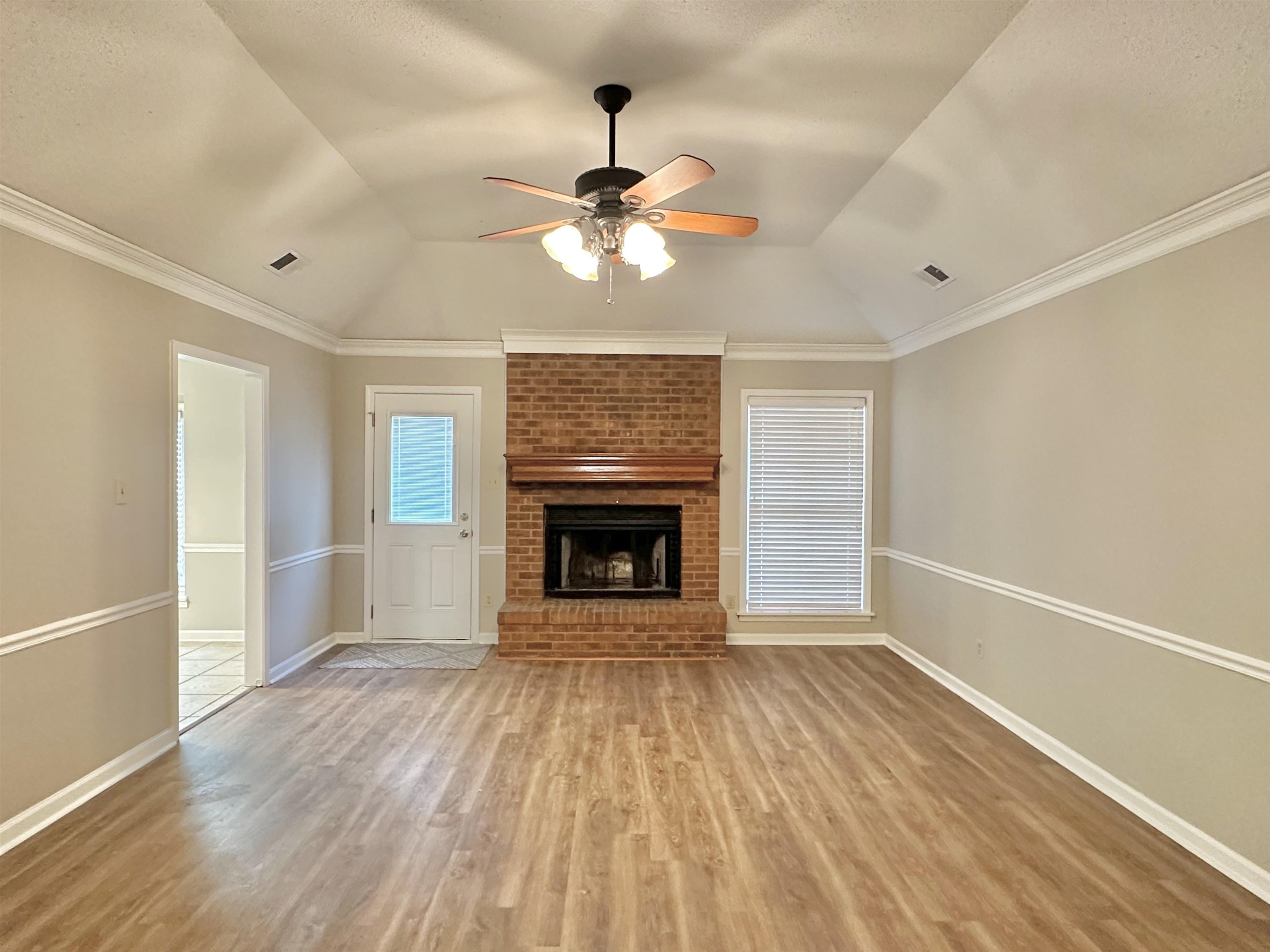 7475 Kingsland Drive Memphis, TN 38125 - Photo 4 of 32 a view of an empty room with a window and a fireplace