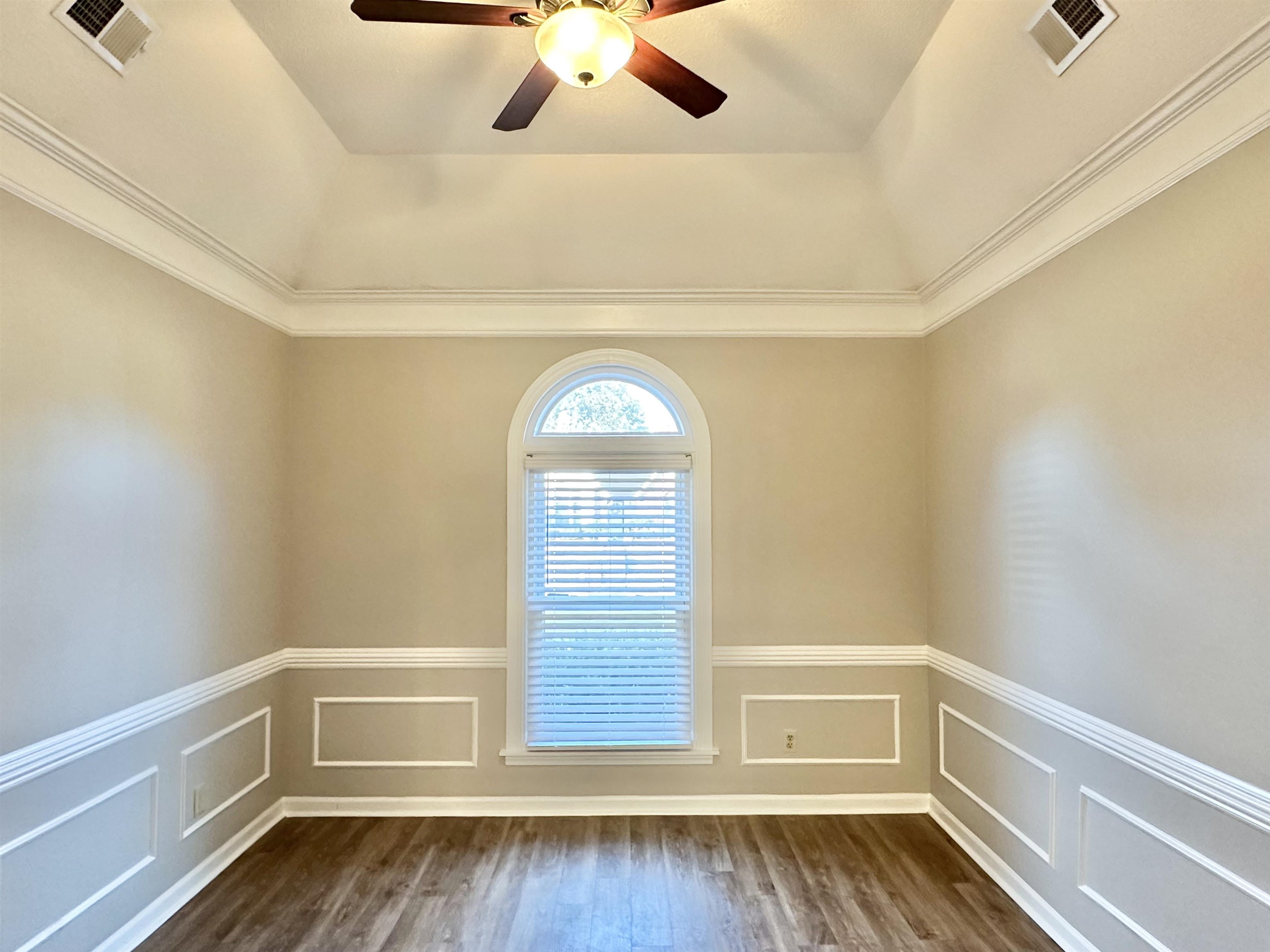7475 Kingsland Drive Memphis, TN 38125 - Photo 10 of 32 a view of an empty room with a window and wooden floor
