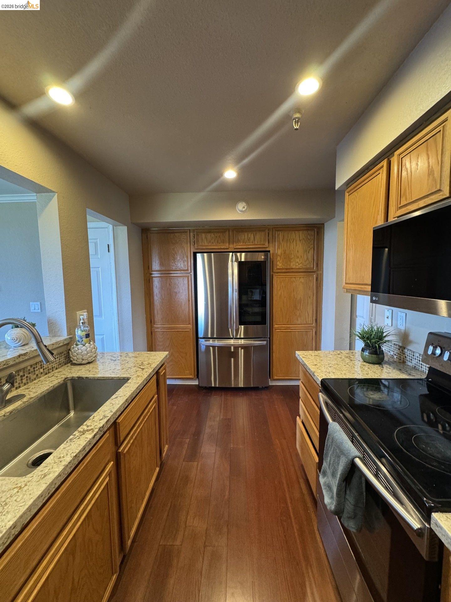 3623 Wells Road Oakley, CA 94561 - Photo 19 of 75 Kitchen featuring wood-finish flooring, recessed lighting, and granite-finish countertops