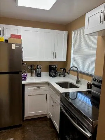 a kitchen with a sink appliances and cabinets