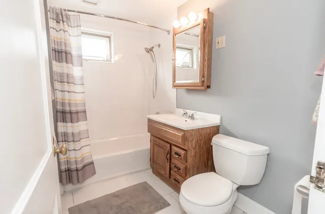 a bathroom with a toilet a sink and bathtub