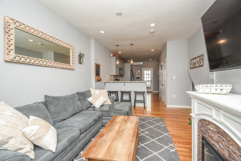 266 Bowen Street, Unit 1 Boston, MA 02127 - Photo 12 of 33 a living room with furniture and a fireplace