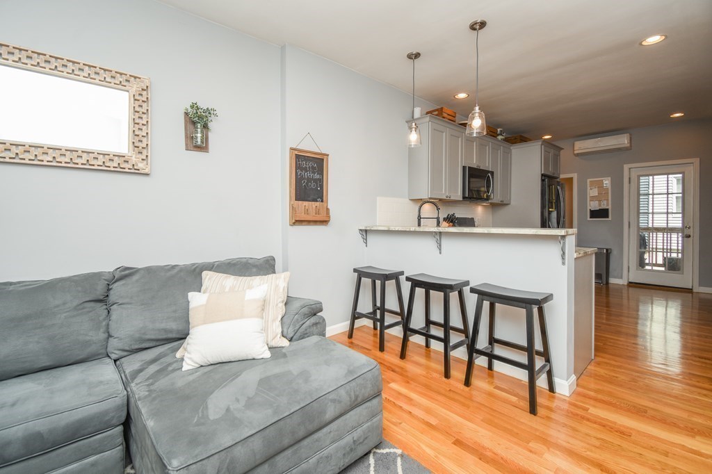 266 Bowen Street, Unit 1 Boston, MA 02127 - Photo 15 of 33 a living room with furniture and a wooden floor