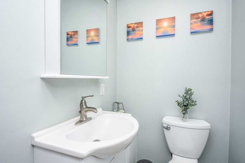266 Bowen Street, Unit 1 Boston, MA 02127 - Photo 16 of 33 a bathroom with a toilet sink and mirror