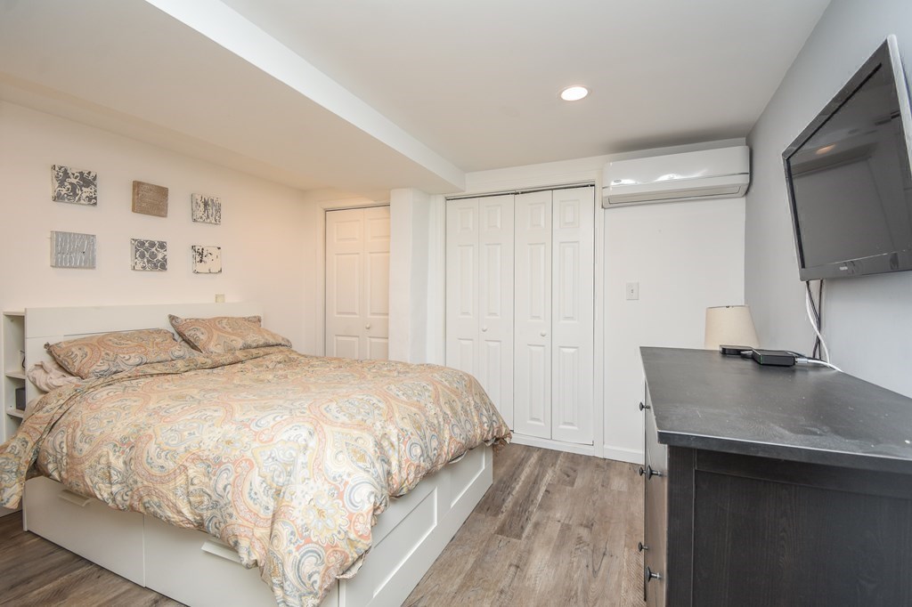 266 Bowen Street, Unit 1 Boston, MA 02127 - Photo 17 of 33 a spacious bedroom with a bed and a flat screen tv