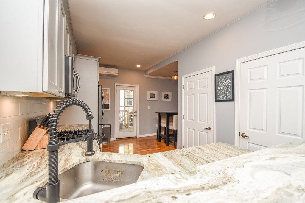 266 Bowen Street, Unit 1 Boston, MA 02127 - Photo 2 of 33 a kitchen with granite countertop a sink and a stove top oven