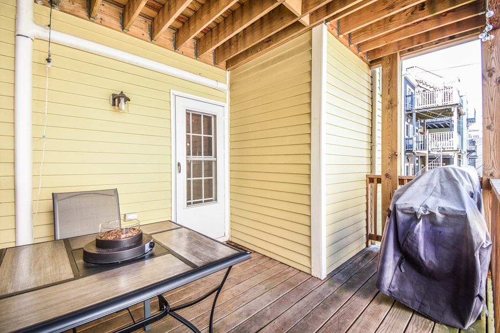 266 Bowen Street, Unit 1 Boston, MA 02127 - Photo 27 of 33 a view of a wooden table and chairs in porch