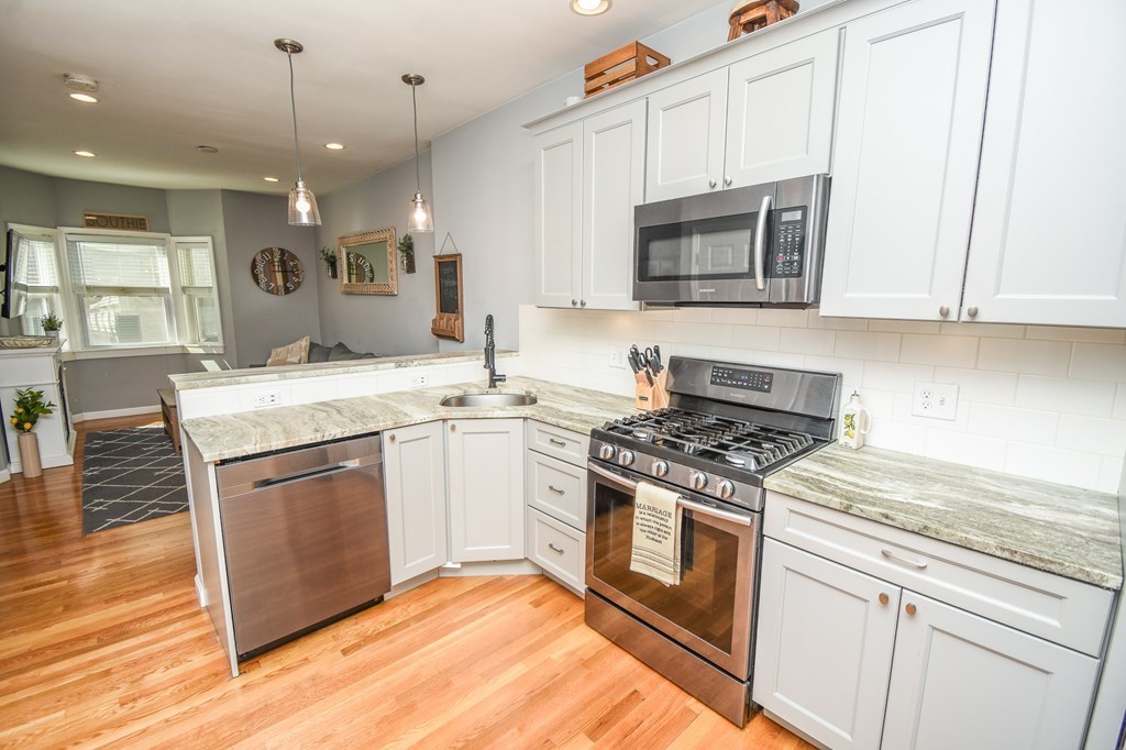 266 Bowen Street, Unit 1 Boston, MA 02127 - Photo 4 of 33 a kitchen with a stove and a microwave