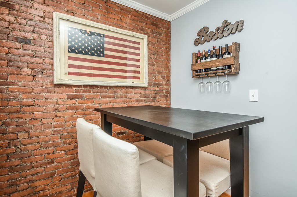 266 Bowen Street, Unit 1 Boston, MA 02127 - Photo 6 of 33 a room with a table and a painting on the wall