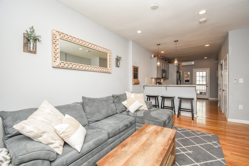 266 Bowen Street, Unit 1 Boston, MA 02127 - Photo 10 of 33 a living room with furniture and a wooden floor