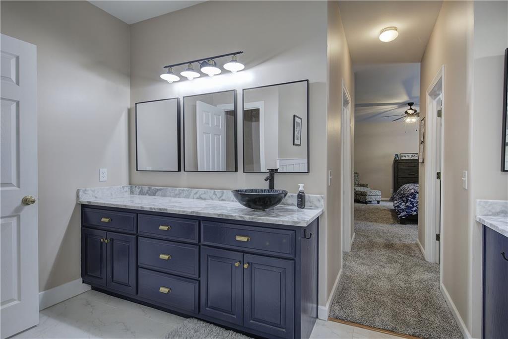 181 Fox Den Circle Jasper, GA 30143 - Photo 37 of 111 a spacious bathroom with a granite countertop sink a mirror and a shower