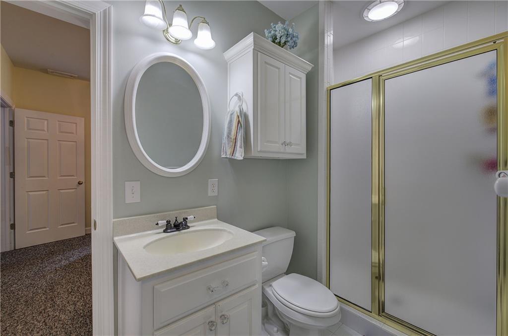 181 Fox Den Circle Jasper, GA 30143 - Photo 62 of 111 a bathroom with a toilet a sink a mirror a vanity and shower