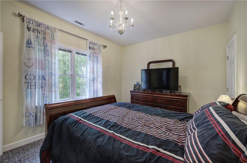 181 Fox Den Circle Jasper, GA 30143 - Photo 64 of 111 a bedroom with a bed and a flat screen tv