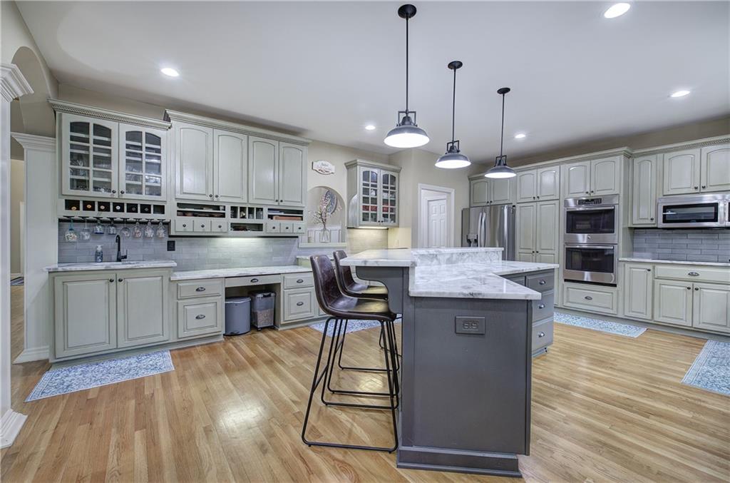 181 Fox Den Circle Jasper, GA 30143 - Photo 7 of 111 a kitchen with stainless steel appliances kitchen island granite countertop a stove a sink a center island and a wooden cabinets