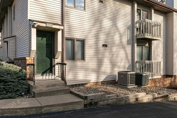 a view of entrance of house and wooden deck
