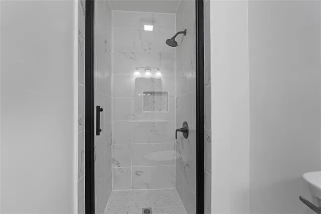 a bathroom with a glass shower door