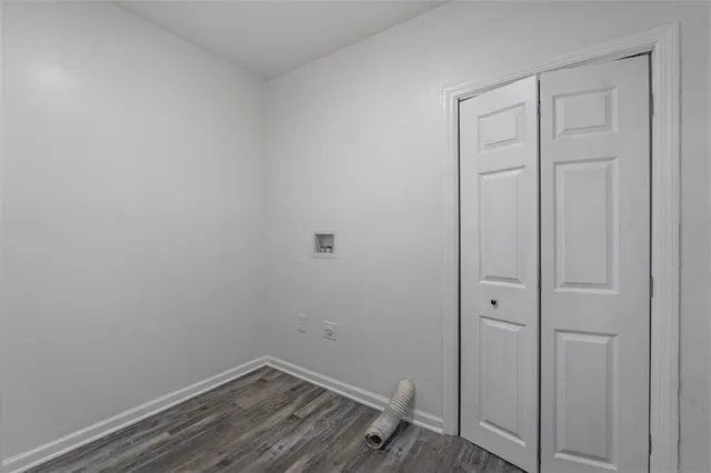a view of a room with wooden floor