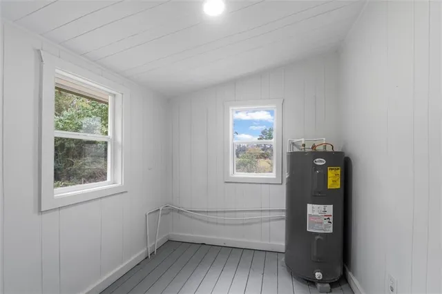 a view of an entryway with wooden floor and cabinet