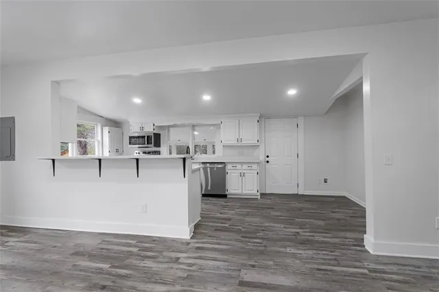a view of kitchen with cabinets and wooden floor