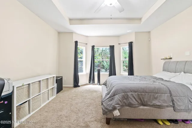 a bathroom with a granite countertop sink a toilet and a mirror