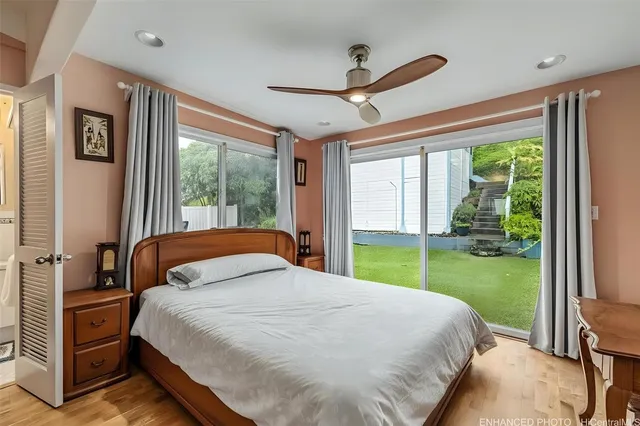 a bedroom with a bed and large window