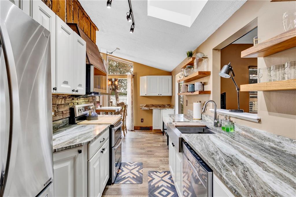1233 Old Concord Road Monroeville, PA 15146 - Photo 13 of 40 a kitchen with granite countertop a sink stove and cabinets