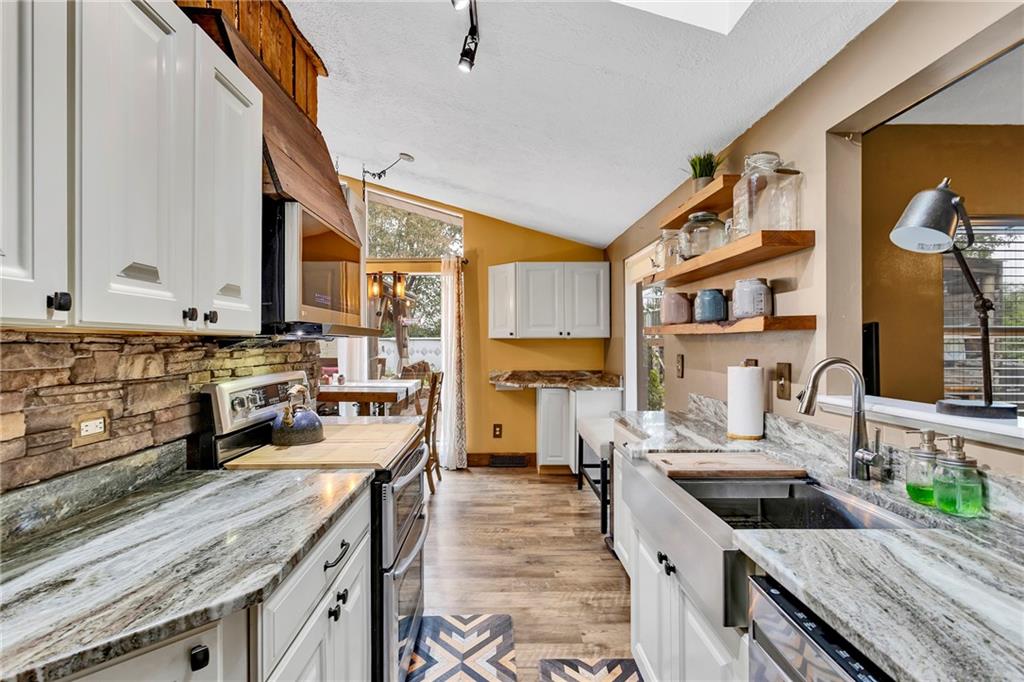1233 Old Concord Road Monroeville, PA 15146 - Photo 14 of 40 a kitchen with stainless steel appliances granite countertop a stove a sink and a microwave