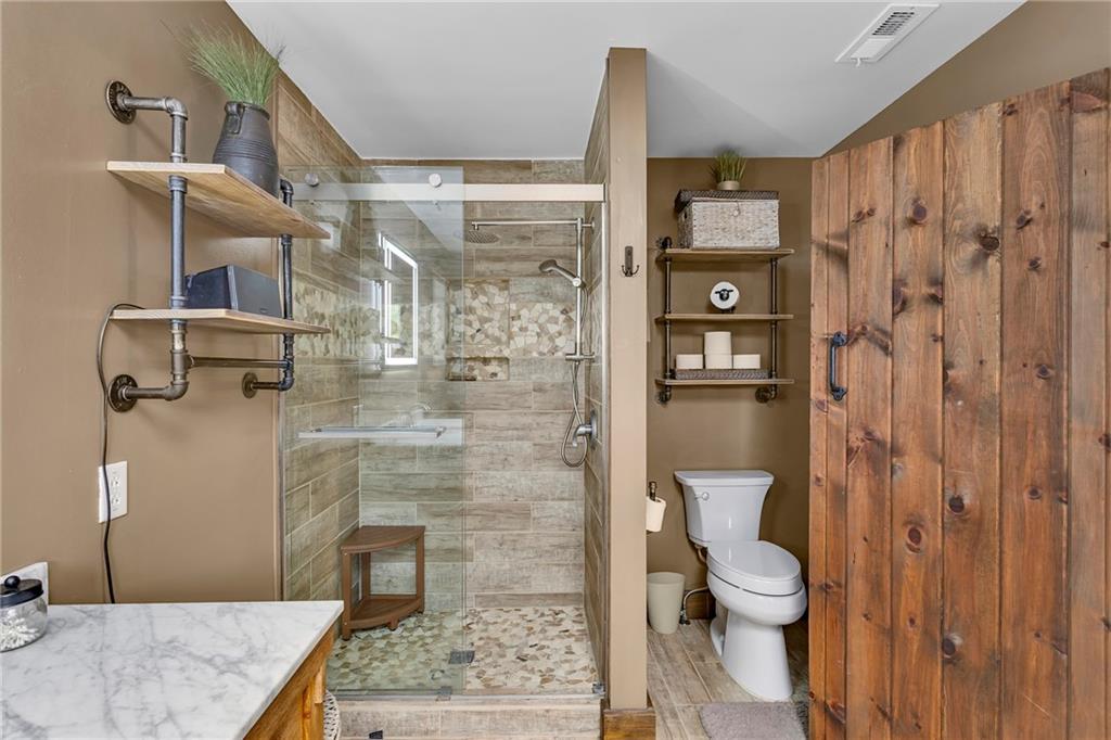 1233 Old Concord Road Monroeville, PA 15146 - Photo 20 of 40 a bathroom with a granite countertop shower a toilet and a sink