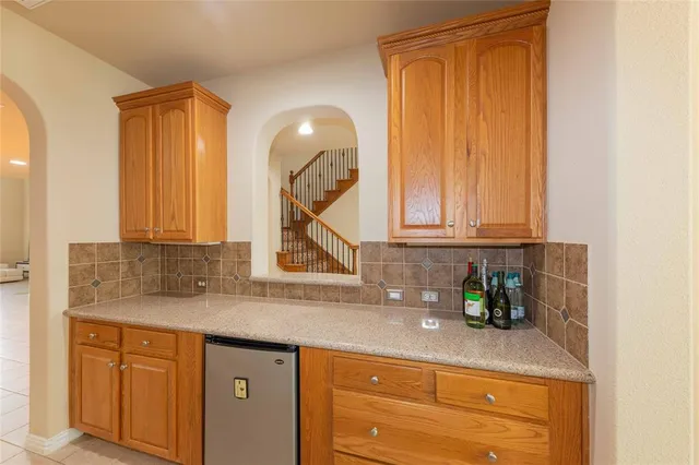 a kitchen with stainless steel appliances granite countertop a sink a cabinets and a window