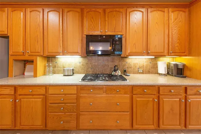 a kitchen with granite countertop cabinets and a stainless steel appliances with wooden floor