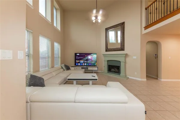 a living room with furniture a fireplace and a flat screen tv