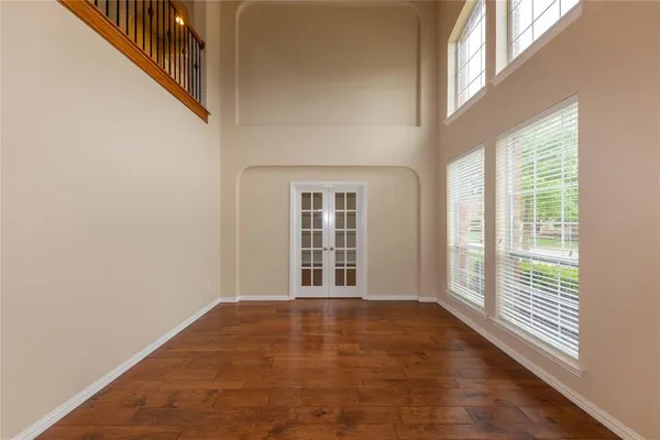 a view of a room with wooden floor and windows