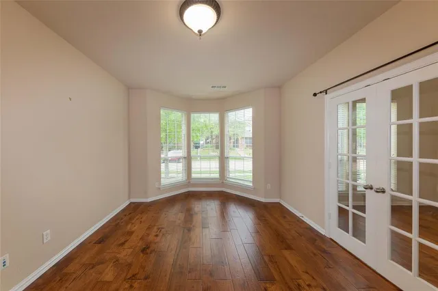 a view of a room with wooden floor and windows