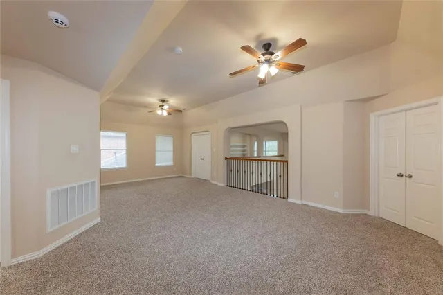 a view of a livingroom with a ceiling fan and window