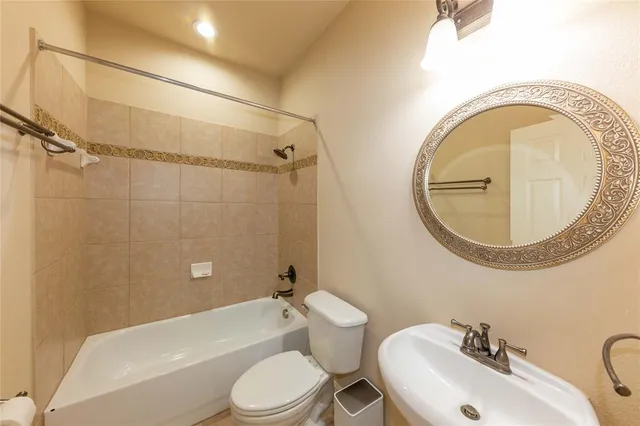 a bathroom with a toilet a sink and bathtub