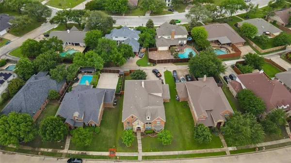 an aerial view of a house with yard