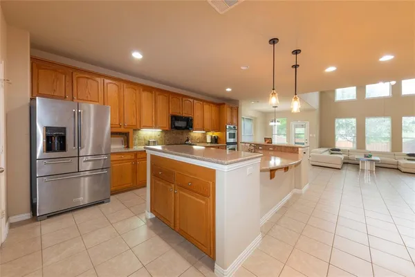 a kitchen with a sink refrigerator and cabinets