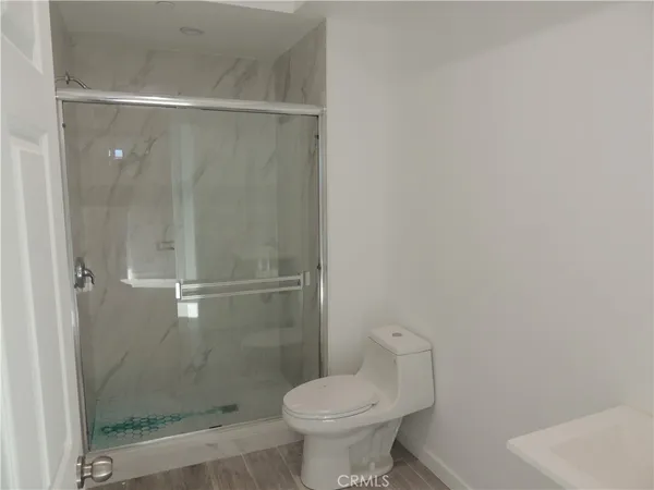 a bathroom with a shower and a toilet