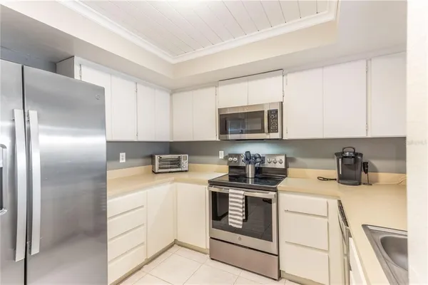 a kitchen with stainless steel appliances granite countertop a sink stove oven a sink with dishwasher and cabinets