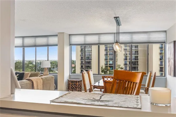 a kitchen with stainless steel appliances granite countertop a refrigerator a stove and a sink with granite countertops